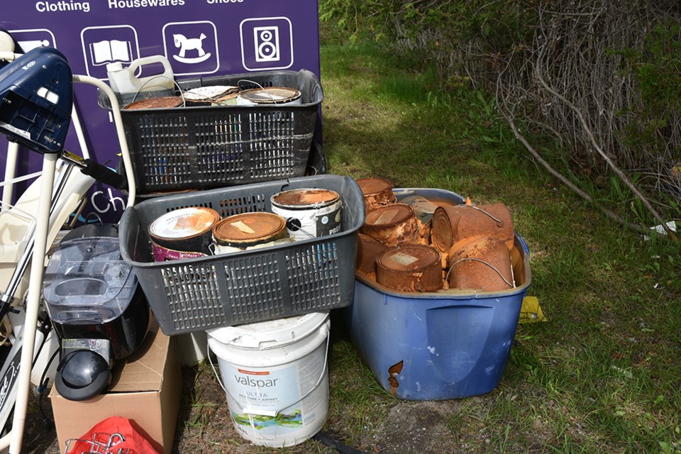 Contractor? Resident? Someone dropped old cans of paint - hazardous waste materials - outside a donation bin on Simcoe Road. Miriam King/Bradford Today