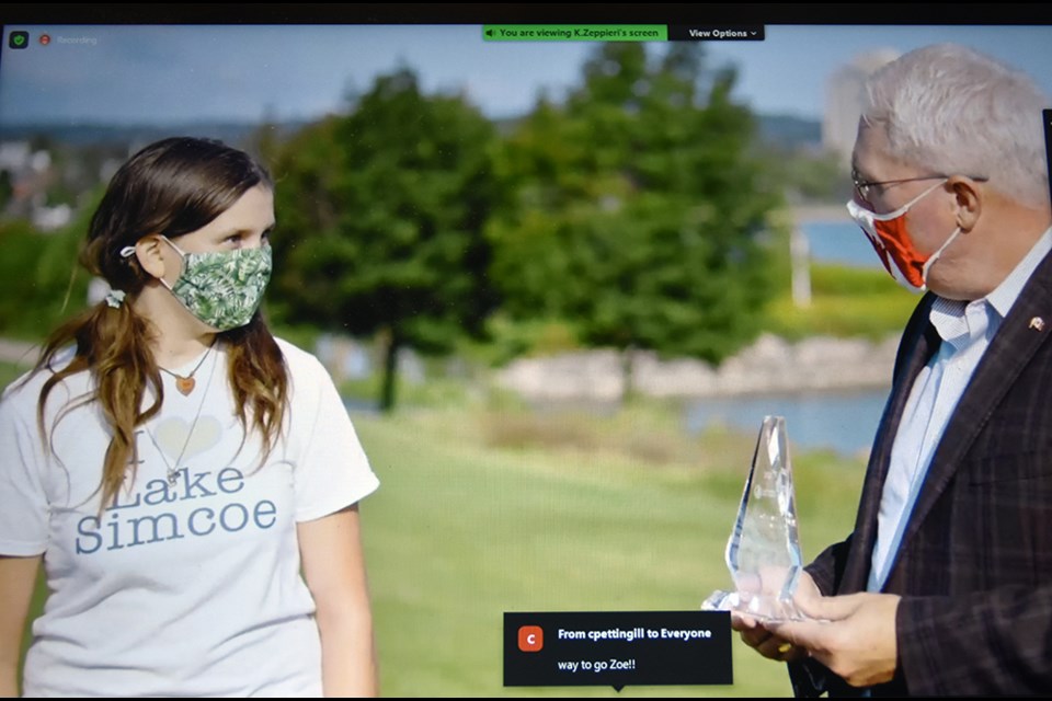 MP for Barrie-Innisfil John Brassard presents Ernie Crossland Young Conservationist award for 2021 to Zoe Bystrov of Barrie, founder of Youth for Lake Simcoe group