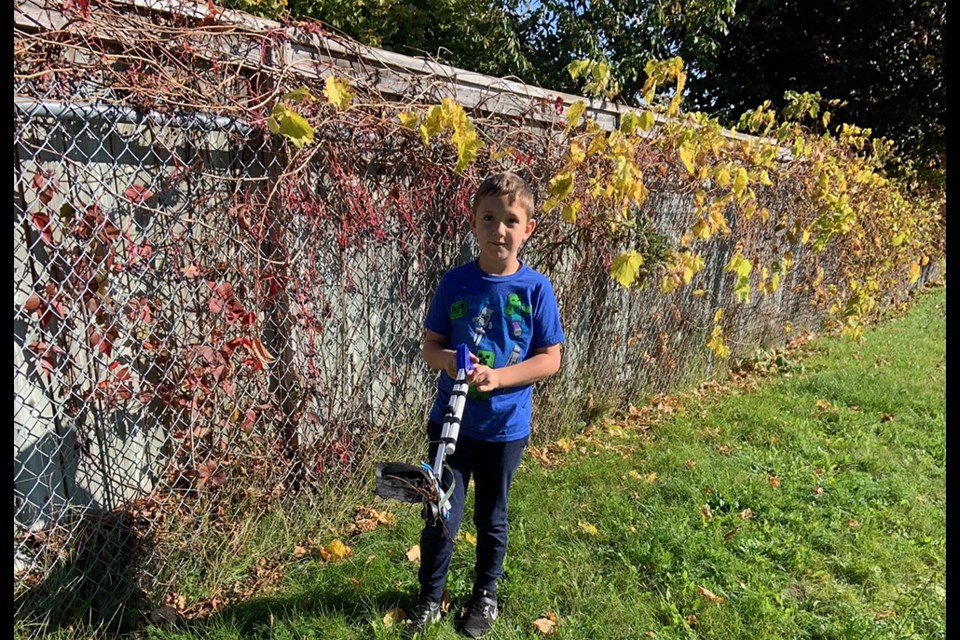 Ryan with the 'grabber-reacher' tool that helps him pick up litter safely.