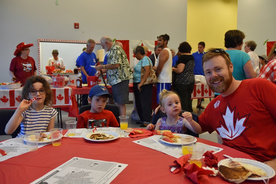Doug and children Adelaide, almost 4, Iain, 6, and Brynna, 8, at MP Peter Van Loan’s annual Dominion Day breakfast, “enjoying the pancakes!” Miriam King/Bradford Today