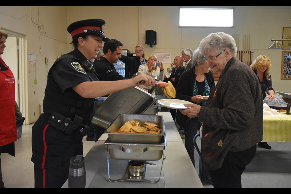 South Simcoe Police Special Const. Elisabeth Aschwanden serves up pancakes at the Danube Seniors Leisure Centre, Oct. 1. Miriam King/BradfordToday