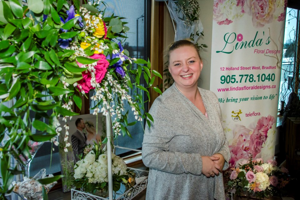 Cassidy Hilliard helps brides-to-be see the beauty and service available from their local florist, Linda's Floral Designs. Dave Kramer for BradfordToday.