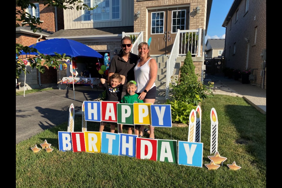 Birthday Boy Owen with little brother Joe, and mom and dad Kira and Mike and sign from local business Invitique - Design Studio. Natasha Philpott/BradfordToday