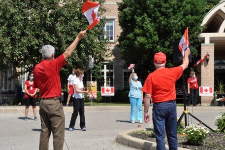 BWG Mayor Rob Keffer raised his flag while singing the national anthem for the staff and residents of the Bradford Valley Care Community. Jackie Kozak/BradfordToday