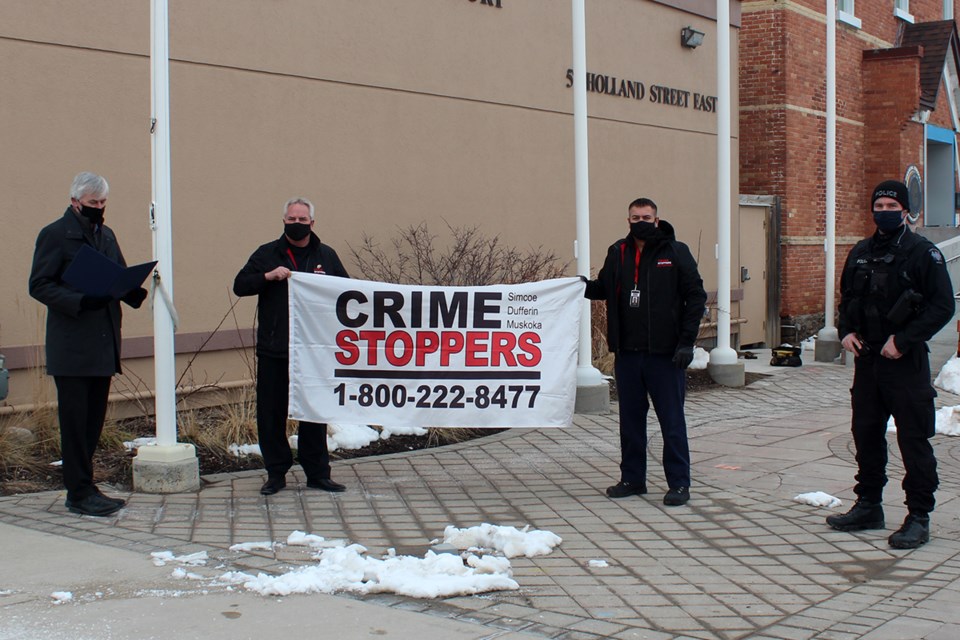 Pictured with Mayor Keffer are the Crime Stoppers board Chair, Dave Cockburn, and the Secretary, Derek Adhiya, along with PC J. McGee from South Simcoe Police.