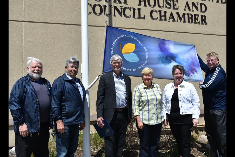 Raising the Compassionate Communities and Hospice Palliative Care flag in Bradford West Gwillimbury, from left: Councillors Gary Lamb and Ron Orr, Mayor Rob Keffer, Matthews House Hospice president Margo Cooney, CEO Kim Woodland, Manager gifts and gratitude Andrea Roylance, Coun. Gary Baynes. Miriam King/Bradford Today