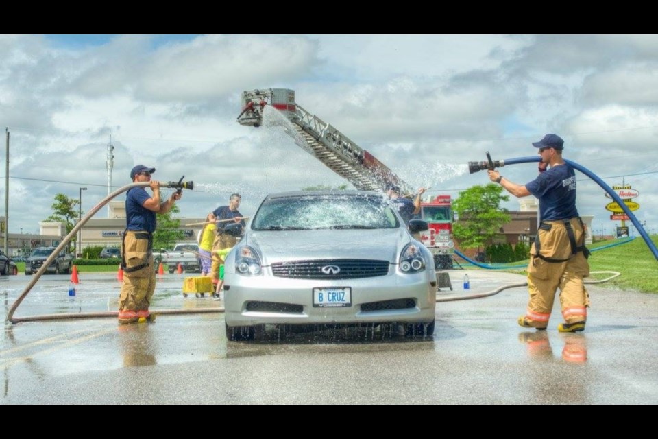 Bradford West Gwillimbury volunteer firefighters take part in an annual car wash for charity. Paul Novasad photo 