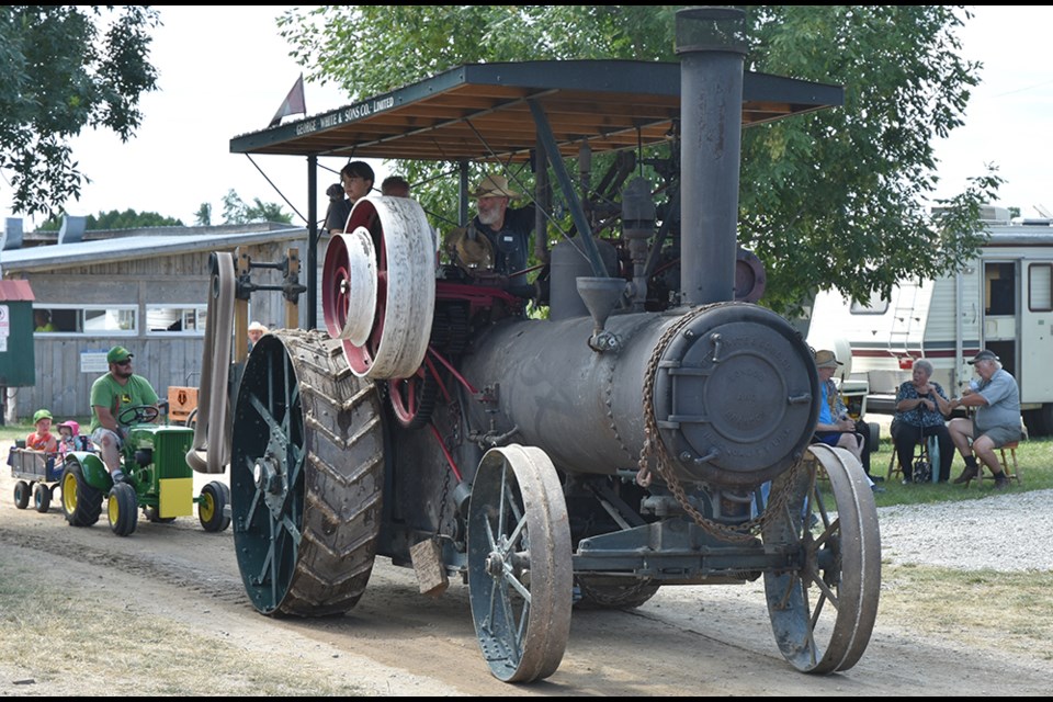 A 1917 George White and Co. Ltd. Steam engine rolls through the grounds followed by a miniature John Deere pulling kids in a wagon. Miriam King/Bradford Today