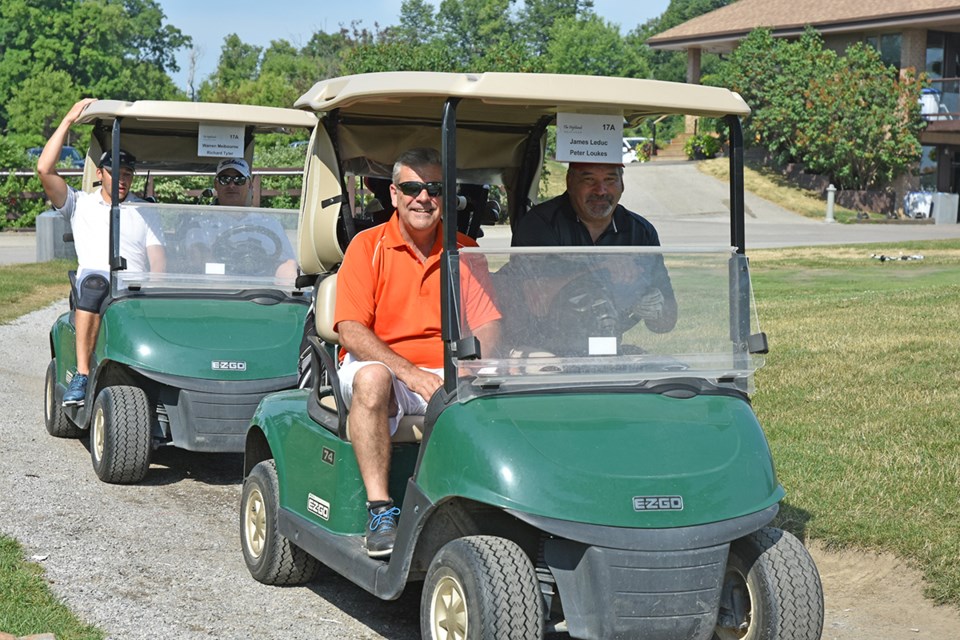 Golfers Deputy Mayor James Leduc and Peter Loukes lead their foursome out onto the course. Miriam King/Bradford Today