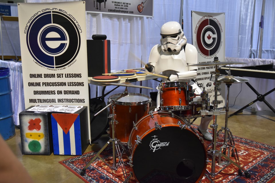Stormtrooper with the 501st Legion tries out the drums at Canadian Drum Gear booth. CDG is a local store and online business that sells percussion instruments and offers lessons. Miriam King/Bradford Today