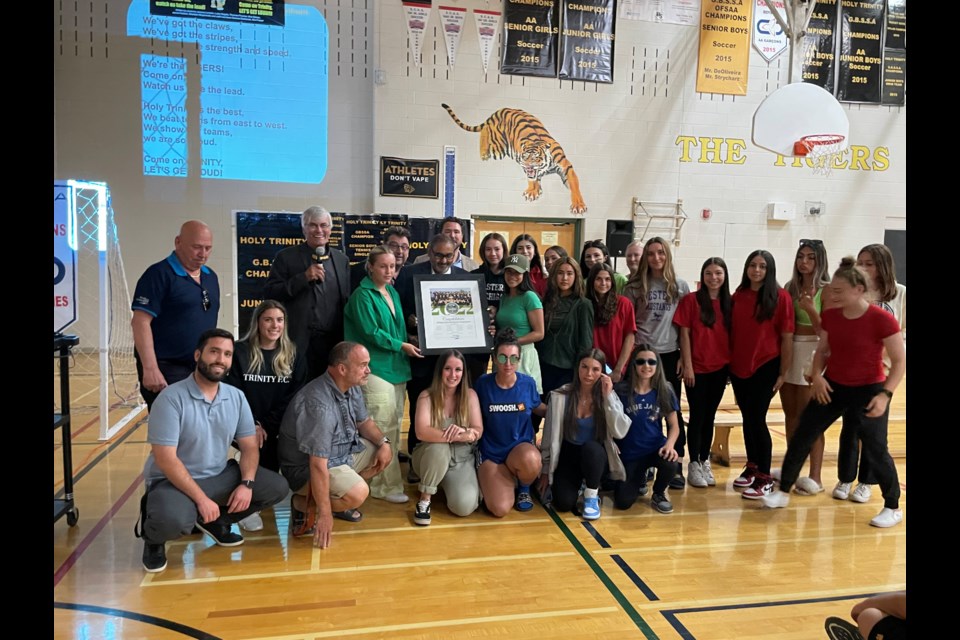 Mayor Rob Keffer and council present the Holy Trinity Tigers girls soccer team with a certificate to commemorate their OFSAA gold season. 