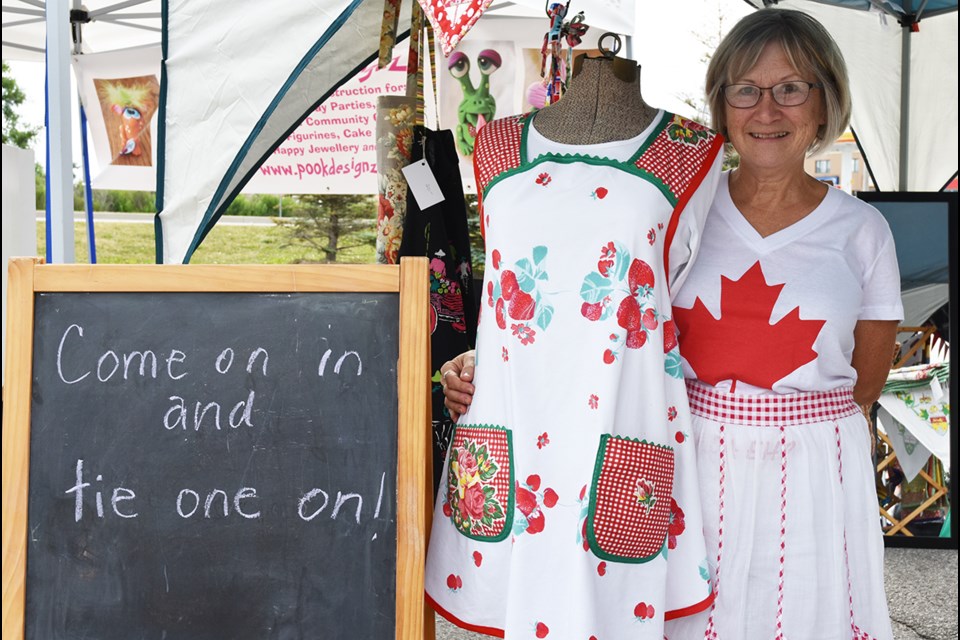 Last year, Pierrette Grondin, owner of Pennies from Heaven crafts, brought her handmade aprons and quilts to the Bradford Farmers’ Market – and dressed up for Canada Day. Miriam King for BradfordToday