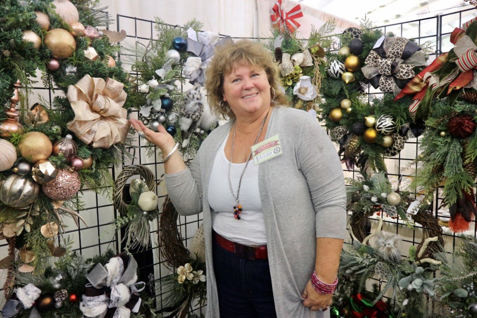 ‘ Xmas Alex’ proudly displays her handcrafted wreaths and holiday decor at the 36th annual Sugar Plum Craft Fair at the Nottawasaga Inn Resort. Natasha Philpott/BradfordToday                    