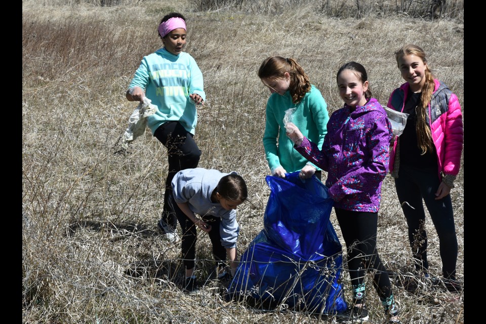 Grade 6 students from Chris Hadfield Public School pick up litter near Fraser Creek on April 30. Miriam King/Bradford Today