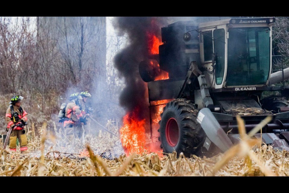 Bradford firefighters extinguish fire that engulfed combine in cornfield.