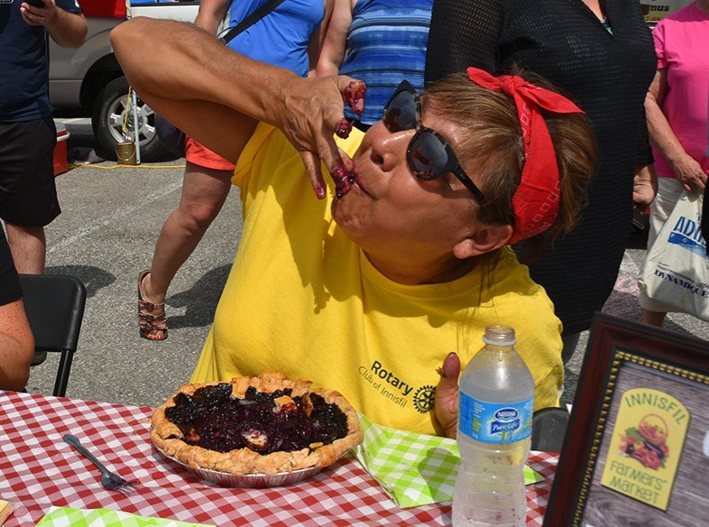 Judy Anne Carter of the Innisfil Rotary Club demonstrates grace under pressure in the pie-eating contest. Miriam King/BradfordToday