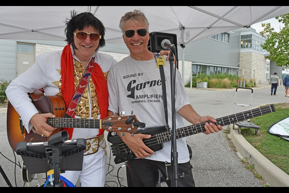 Elvis (Russ Clayton) is joined by Pat Gowan, entertaining at the Bradford Farmers’ Market, Aug. 25. Miriam King/BradfordToday