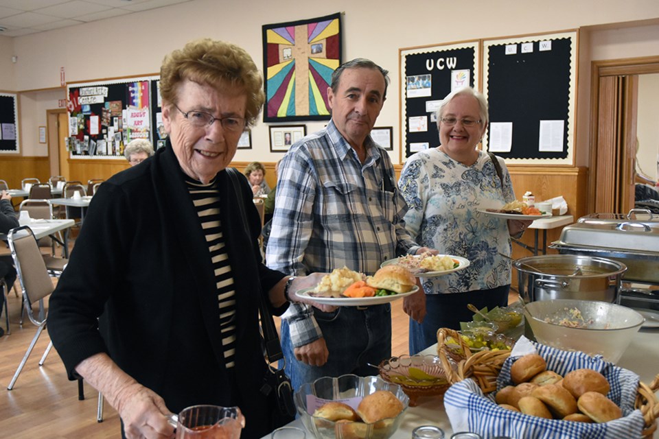 Serving up heaping plates of mashed potatoes, roast beef and gravy, vegetables and salad, at Bradford United Church. Miriam King/Bradford Today