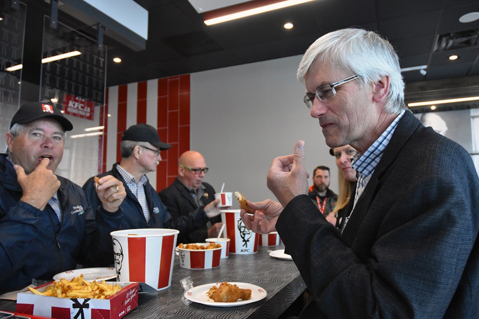 Finger-lickin' good. Mayor Rob Keffer, right, and councillors demonstrate, at the opening of KFC in Bradford, June 4. Miriam King/Bradford Today