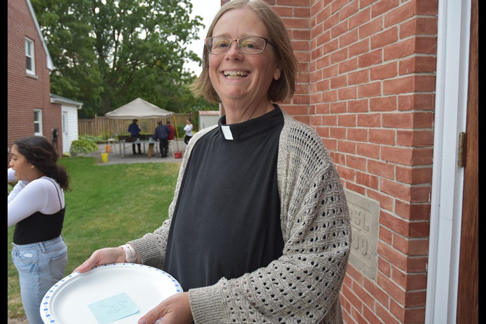Rev. Dana Dickson welcomes diners to Trinity Anglican Church's annual Steak Barbecue. Miriam King/Bradford Today