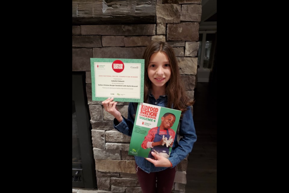 Isabella Palleschi with her award and copy of Kid Food Nation cookbook. 