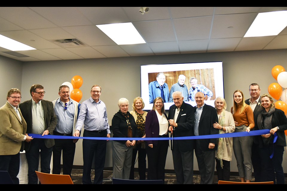 Stewart Fisher, surrounded by family members, Innisfil Mayor Lynn Dollin and Councillors Rob Nicol, Donna Orsatti, Alex Waters and Bill Van Berkel, prepares to cut the ribbon. Miriam King/Bradford Today