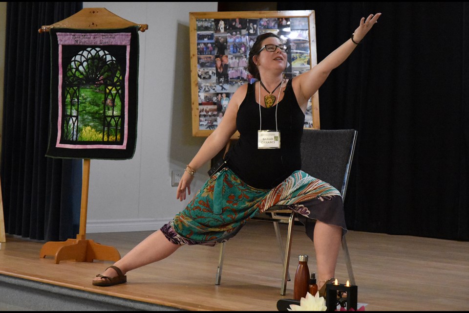 Yoga instructor Sarah Caranci demonstrates the chair warrior, or gardener warrior, pose. Miriam King/Bradford Today