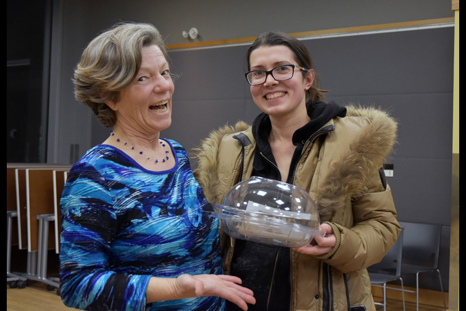 Cathy Nesbitt presents a Sprout Grower to draw winner Karina Sherman, at the Bradford Library. Miriam King/Bradford Today