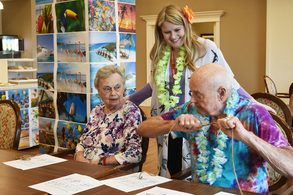 Resident Les Shallows demonstrates how to tie a knot, to staffer Megan Kerr and fellow-resident Peggy McGovern during Cruise Week at Holland Gardens. Miriam King/Bradford Today