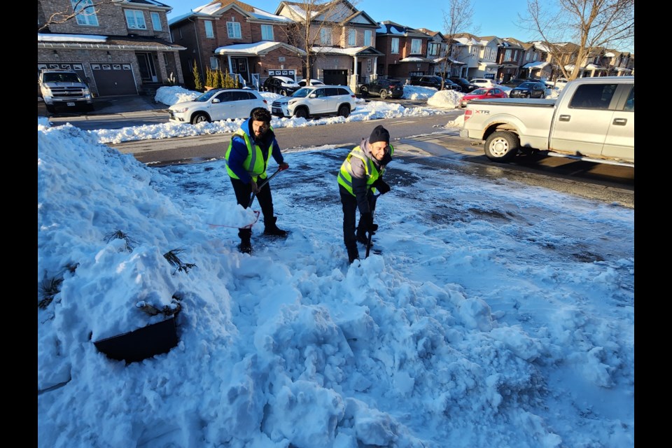 Snow Angels from the Ahmadiyya Muslim Youth Association who cleared driveways last year include Usama Ahmad, left, and Kashif Meer.