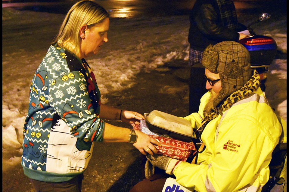 Patti La Rose delivers dinner and gifts to Mike, who had to wait outside because the St. Mary's Building is not handicapped accessible. Miriam King/Bradford Today