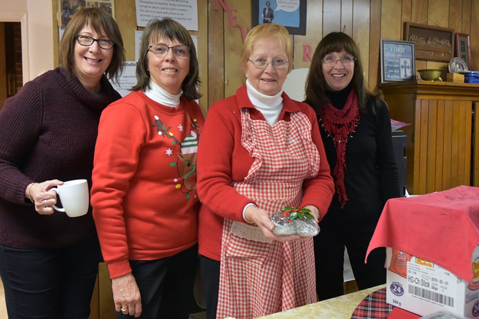 From left, Rhonda Long, Cathy McClure, Vicky Greenaway and Lyn Rutledge with baking – including home-made Christmas Cake, at a Churchill United Church bazaar. Miriam King/BradfordToday