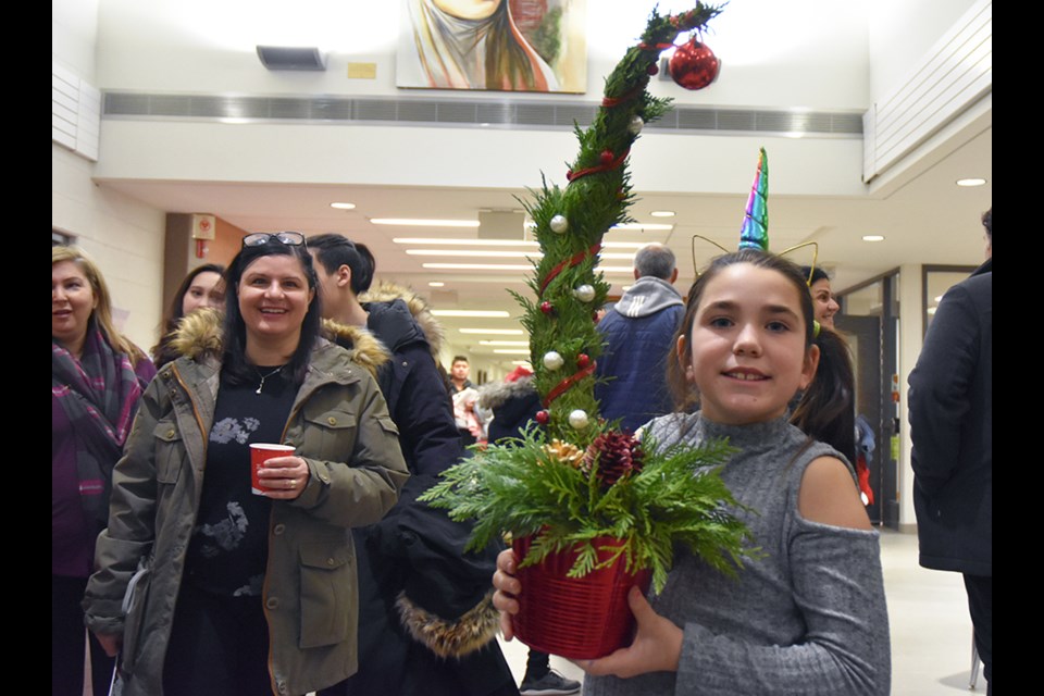 Picking up a 'grinch tree,' at St. Angela Merici Catholic elementary school’s Christmas Bazaar last year. Miriam King/BradfordToday