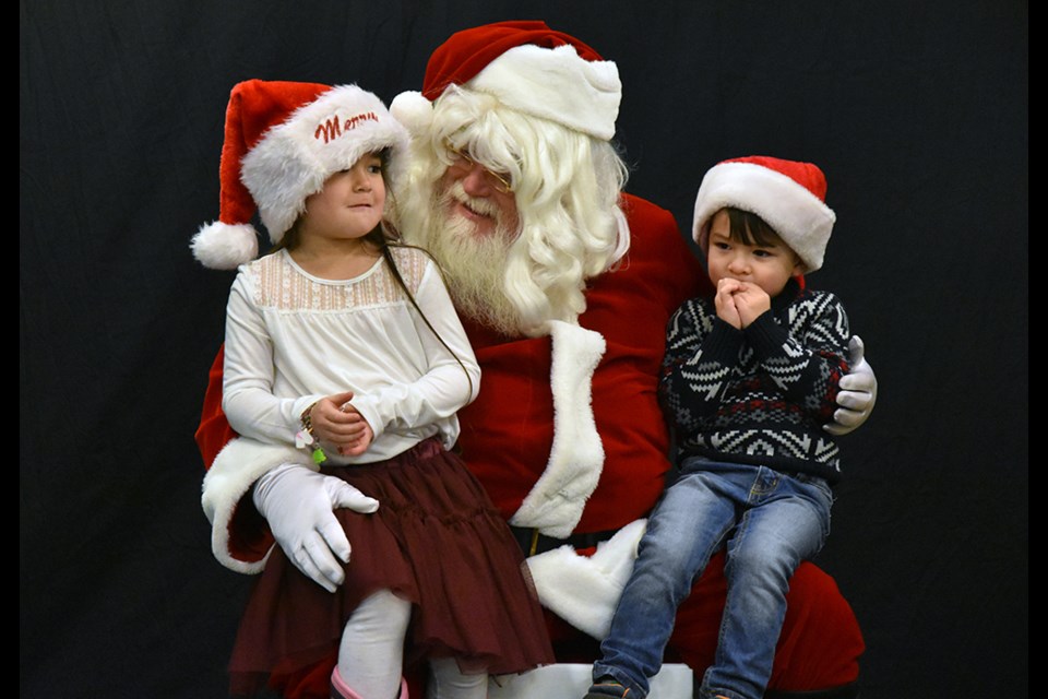 Emersyn, 5, and Hudson, 3 tell Santa their Christmas wishes. Miriam King/Bradford Today