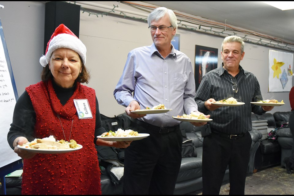 Volunteer Colleen Grogan, Mayor Rob Keffer and Deputy Mayor James Leduc get ready to take out the first plates, at CrossTrainers'  Christmas Wish List Dinner, Dec. 9. Miriam King/Bradford Today