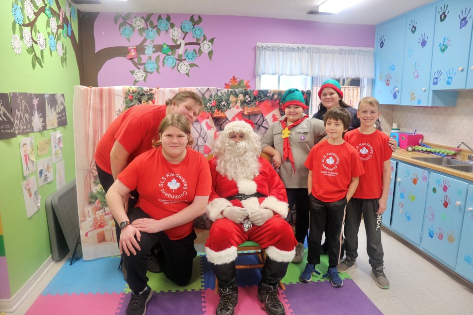 Scout volunteers grab a photo with Santa. Natasha Philpott/BradfordToday                               