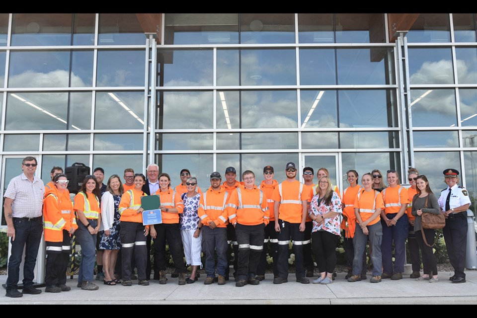 Some of the 49 summer students hired by the Town of Innisfil join Mayor Lynn Dollin, Innisfil Councillors Kevin Eisses, Carolyn Payne and Bill van Berkel, and MP John Brassard at the Operations Centre. Miriam King/Bradford Today