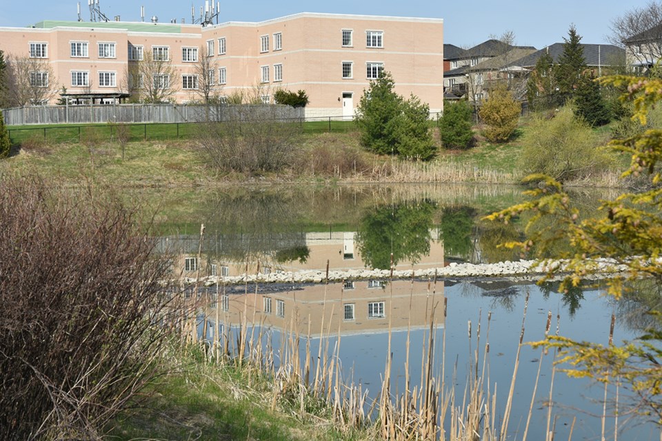 Bradford Valley Care Community, reflected in a stormwater pond on Line 6. Miriam King/Bradford Today