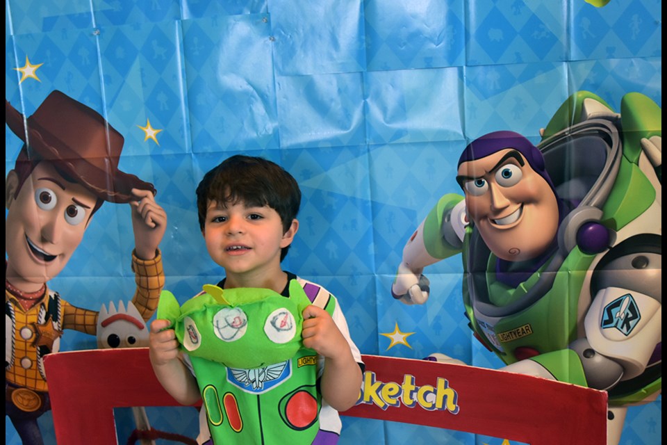 Julian, 3, wore his Buzz Lightyear t-shirt, and posed with Woody and Buzz at the library. Miriam King/Bradford Today