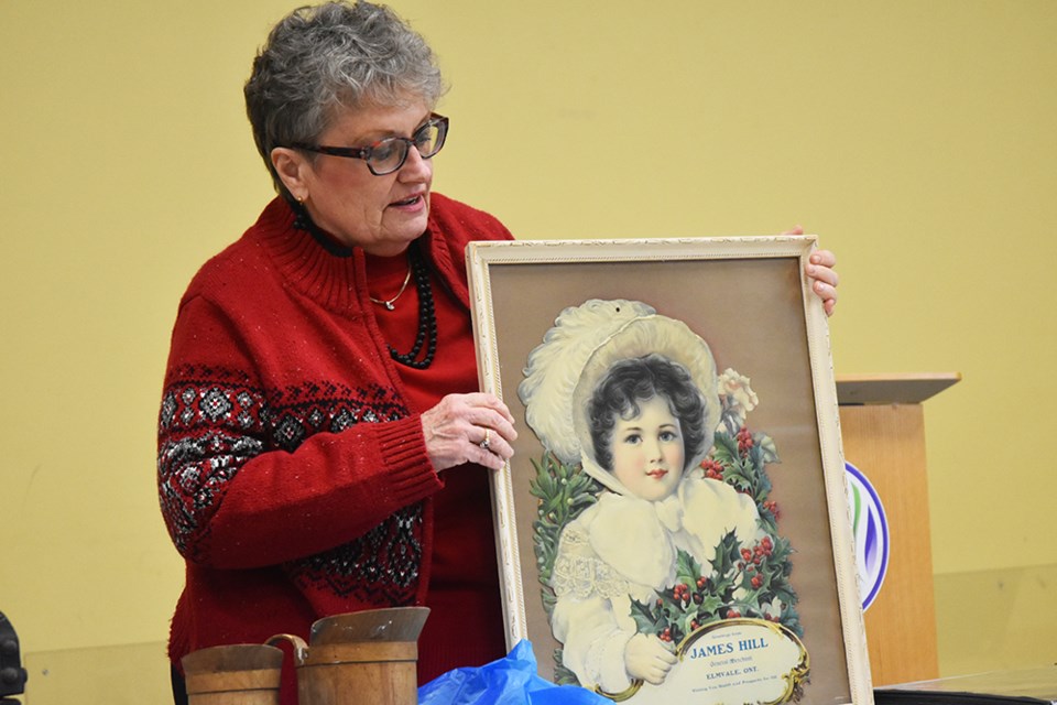 Nancy Young with framed calendar circa 1911, at the BWG Local History Association's January Show and Tell. Miriam King/Bradford Today