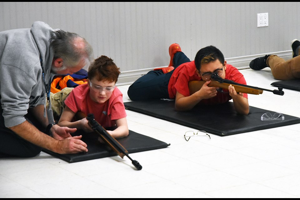 Load, pump, aim - Air Cadets with 37 Flight get help at rifle practice. Miriam King/Bradford Today