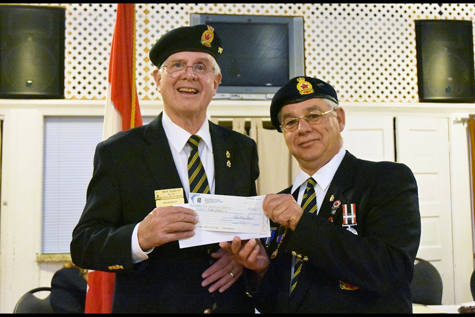 Lottery winner Derek Francis, right, presents a cheque to Lefroy-Belle Ewart Legion president Mark Southcott, for the building fund. Miriam King/Bradford Today