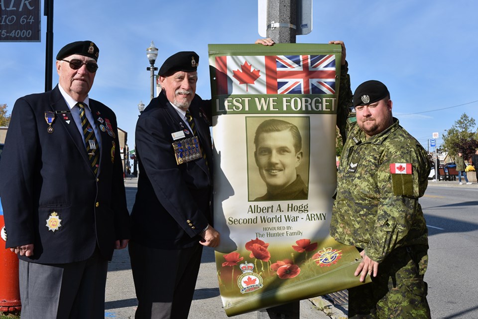 From left, Legionnaires George Neilson, Mike Giovanetti and Cpl. Kirk St. John, with Veteran Banner of the late Bert Hogg. Miriam King/Bradford Today