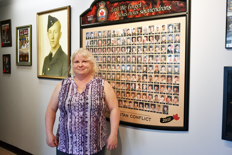 Legion President Tammy Paglia in front of the renovated Veterans' Wall. Miriam King/Bradford Today