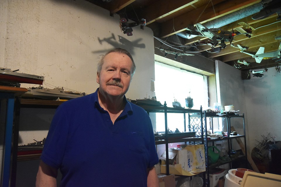 Jim MacIvor, in his basement workshop, with model planes and ships. Miriam King/Bradford Today