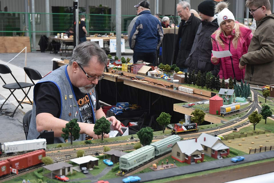 Dave Nightingale, of the Belleville Model Railway Club, at work on the layout at the Model Train Show in Barrie this weekend. Miriam King/Bradford Today