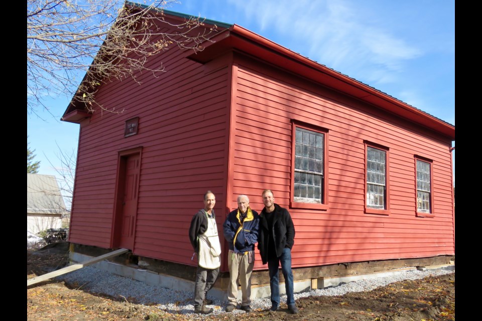 From left: Bruce, David and Kent Chambers stand together after giving S.S. No. 6 Middleton School, built in 1850, a new foundation.