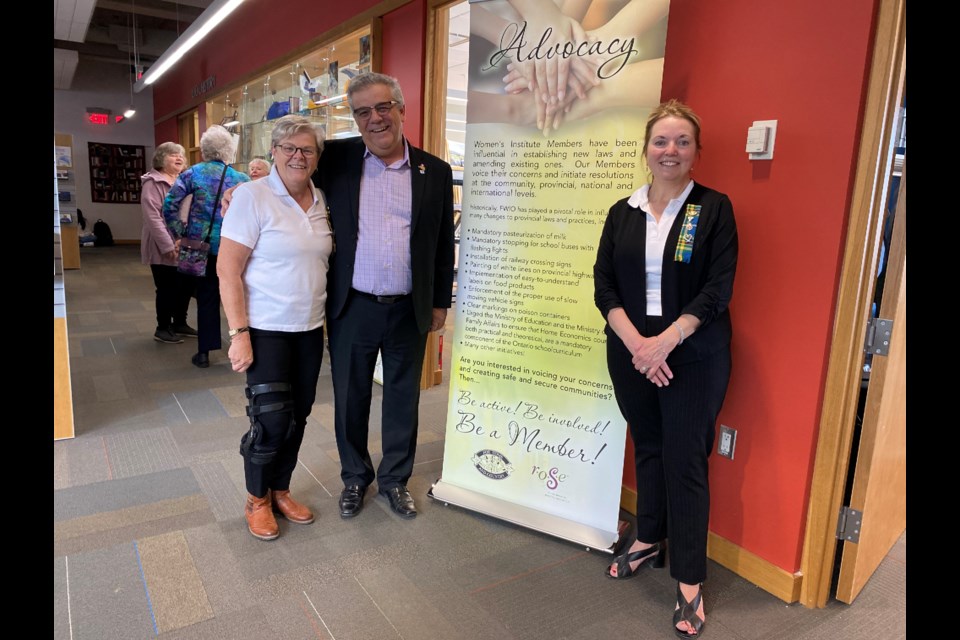 From left: Donna Jebb, president of the Tec-We-Gwill Women’s Institute (WI), Bradford West Gwillimbury Mayor James Leduc and Bond Head WI president Liz Moore are shown with a sign at the Bradford West Gwillimbury Public Library educating the public about the advocacy work of the WI in Ontario.