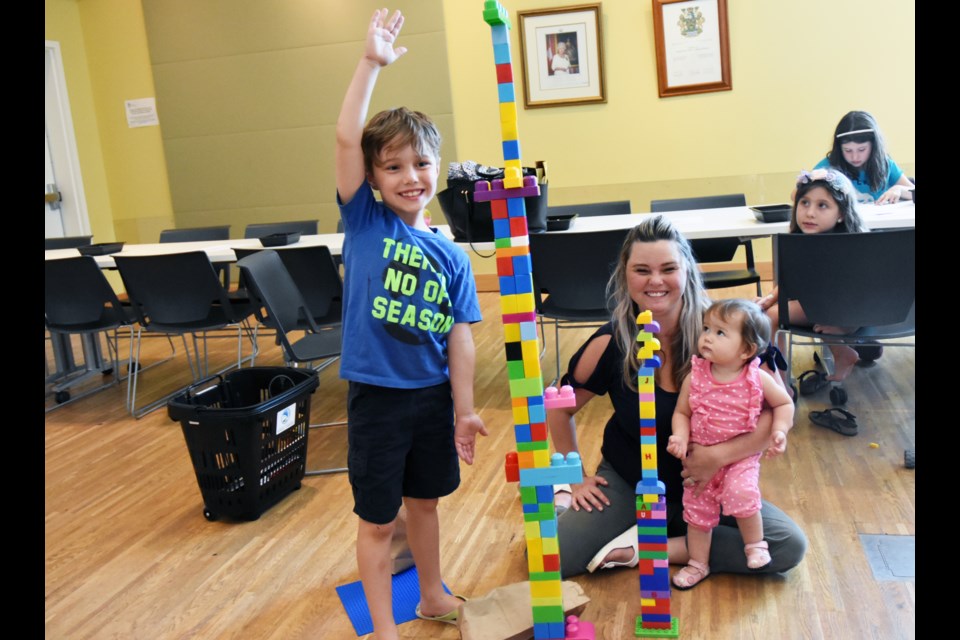 Nicolas, seven, took less than 10 minutes to build a LEGO tower that was as tall as he could reach – while mom Cheryl had help from one-year-old Quinn on her own structure. “She helped mommy. She handed me the blocks.” Miriam King/BradfordToday