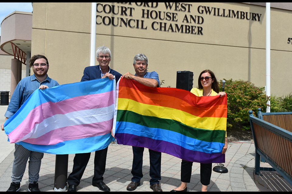 From left: president of Fierte Simcoe Pride Brandon Amyot, BWG Mayor Rob Keffer, Coun. Ron Orr and Karen Gill with the trans and rainbow flags for Fierte Simcoe Pride. Miriam King/BradfordToday